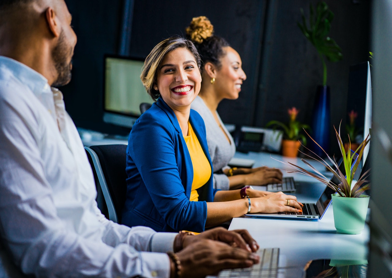 HEalthcare industry case study header image woman in blue suit jacket with laptop